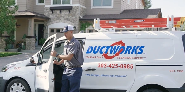 Professional residential air duct cleaning technician arriving at your home