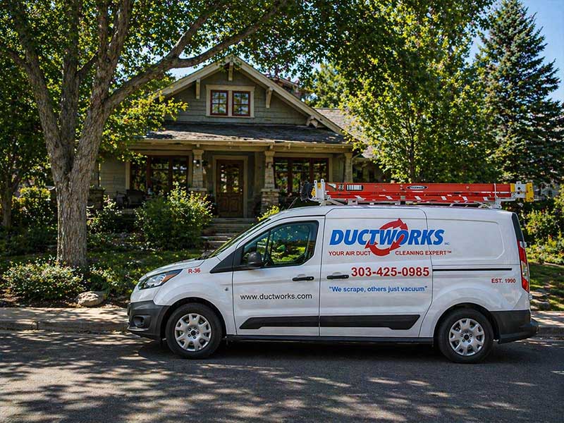 Ductworks air duct cleaning van parked outside a historic Denver Square home in Washington Park