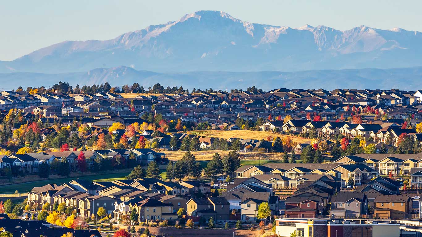 Technician performing residential air duct cleaning in a modern Denver Highlands home